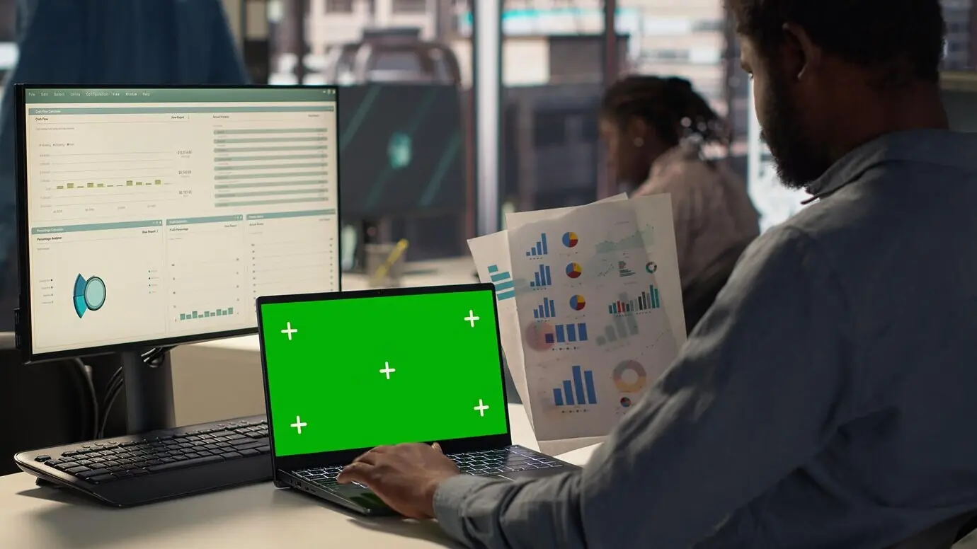 Ejecutivo afroestadounidense analizando datos financieros en una pantalla simulada.
